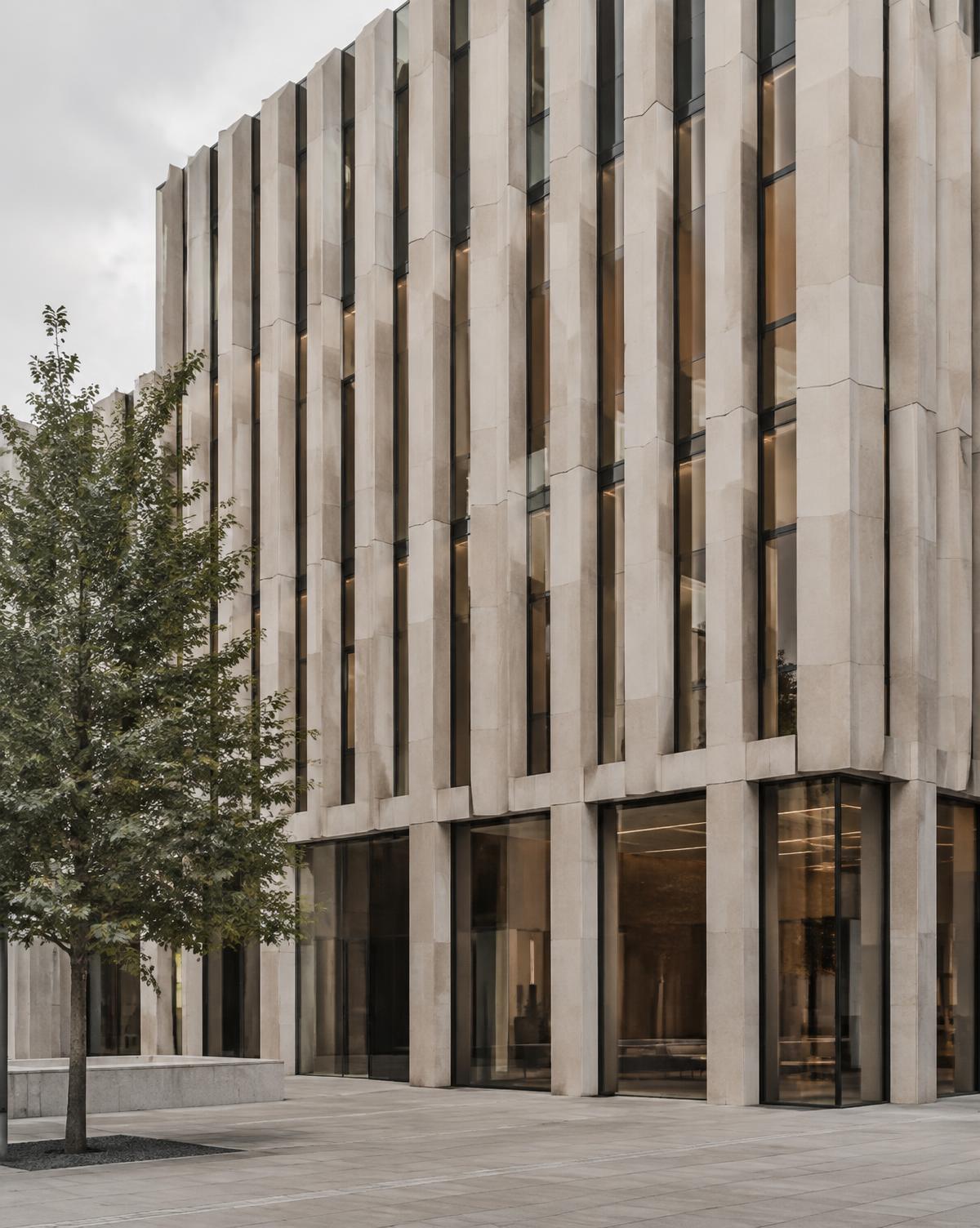 Office facade of vertical limestone fins and bronze glazing